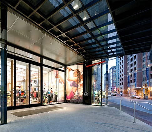 View of the underneath an open Schweiss hydraulic door fitted on Under Armour storefront