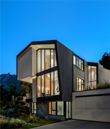Angled side view of the Vergence House, fitted with a Schweiss bifold door on its garage