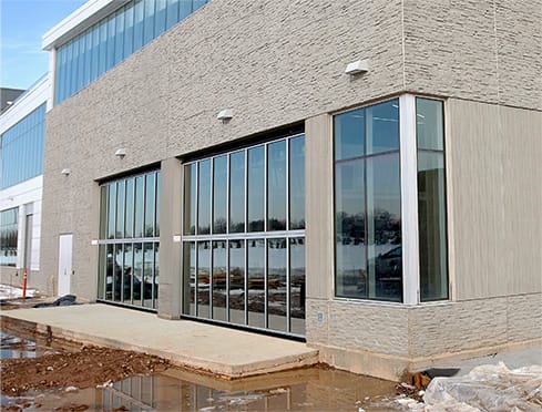 Angled view of two custom Schweiss glass bifold doors installed on the Vikings Training Center in Eagan, MN