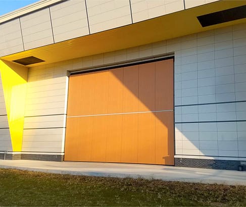 Closeup view of custom Schweiss bifold door fitted on Warren Harding High School