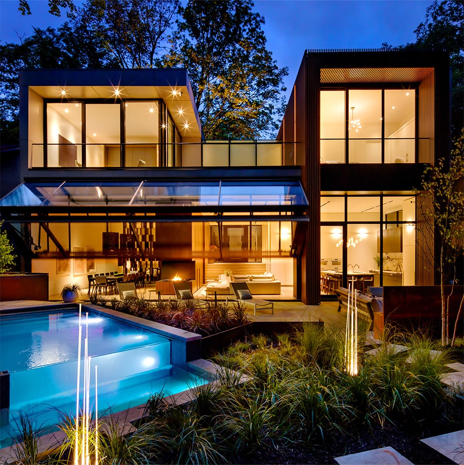 Exterior view of Schweiss bifold door fitted on Waxwing Residence shown during the night