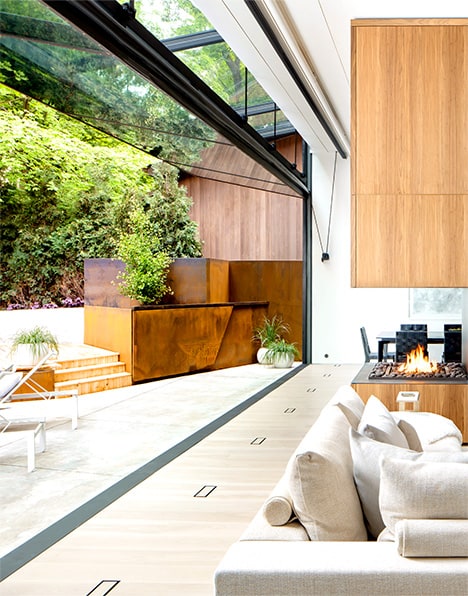 Angled view of Schweiss bifold door fitted on Waxwing Residence shown open