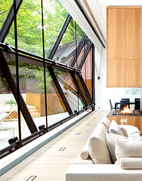 Angled view of Schweiss bifold door fitted on Waxwing Residence shown opening