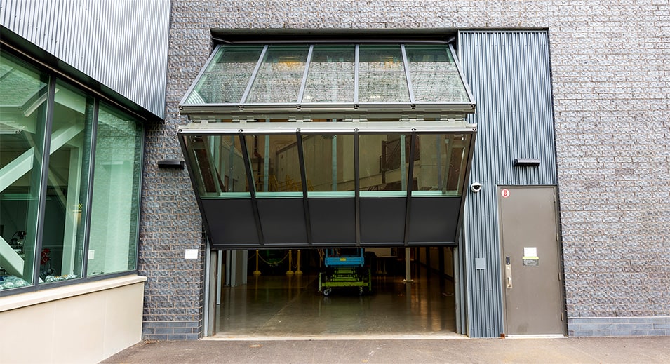 Outside view of Schweiss glass bifold door installed on Wilson West Lab at Cornell's CHESS building shown opening from the front