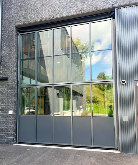 Outside view of Schweiss glass bifold door installed on Wilson West Lab at Cornell's CHESS building shown closed from the right
