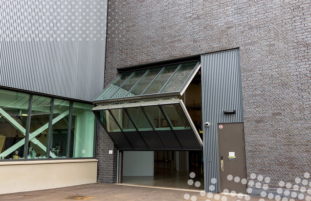 Outside view of Schweiss glass bifold door installed on Wilson West Lab at Cornell's CHESS building shown opening from the right