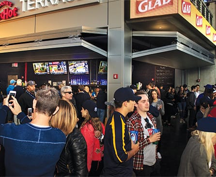 Crowds surround concession stands within Yankee Stadium that are fitted with Schweiss bifold doors