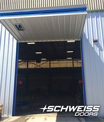 Schweiss Bifold Door is windrated for 90mph and includes a window and automatic latching systems