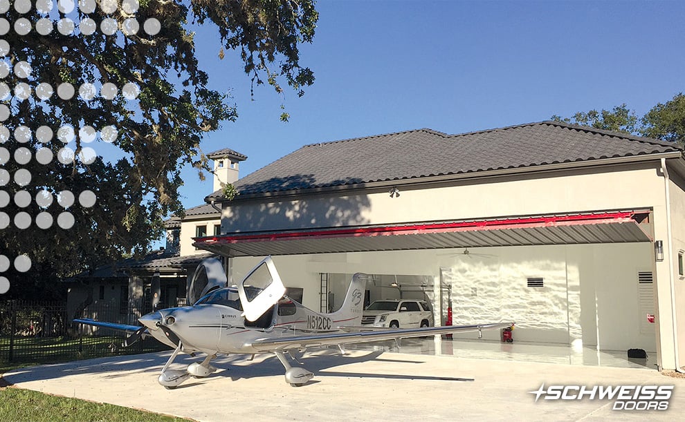 Cirrus plane sitting outside Schweiss Bifold Hangar Door