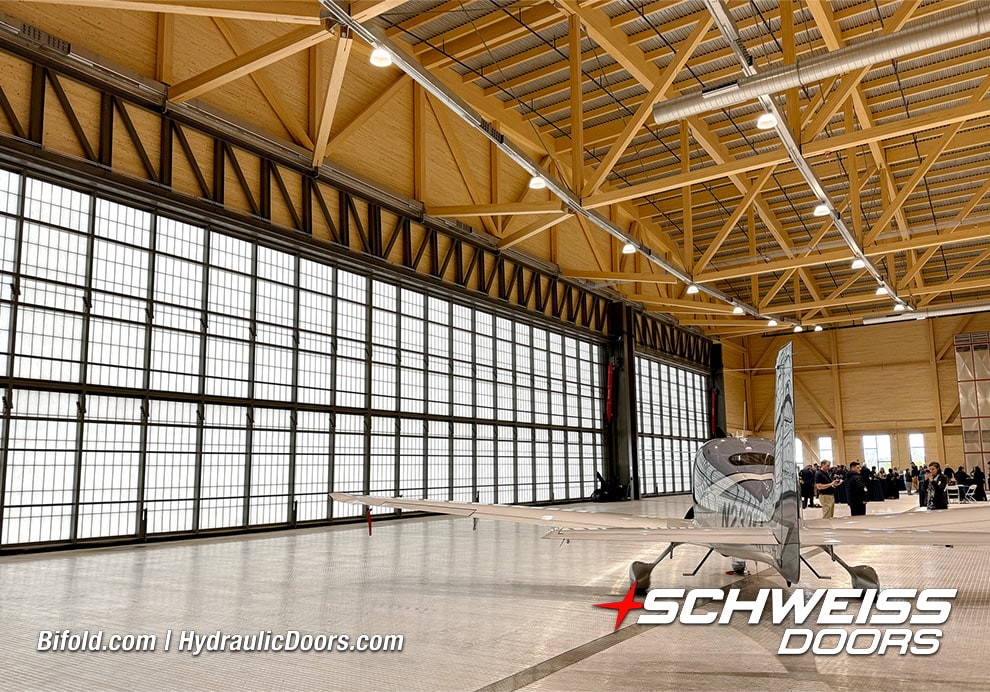 Interior view of 120ft Schweiss hydraulic hangar door shown closed near smaller plane