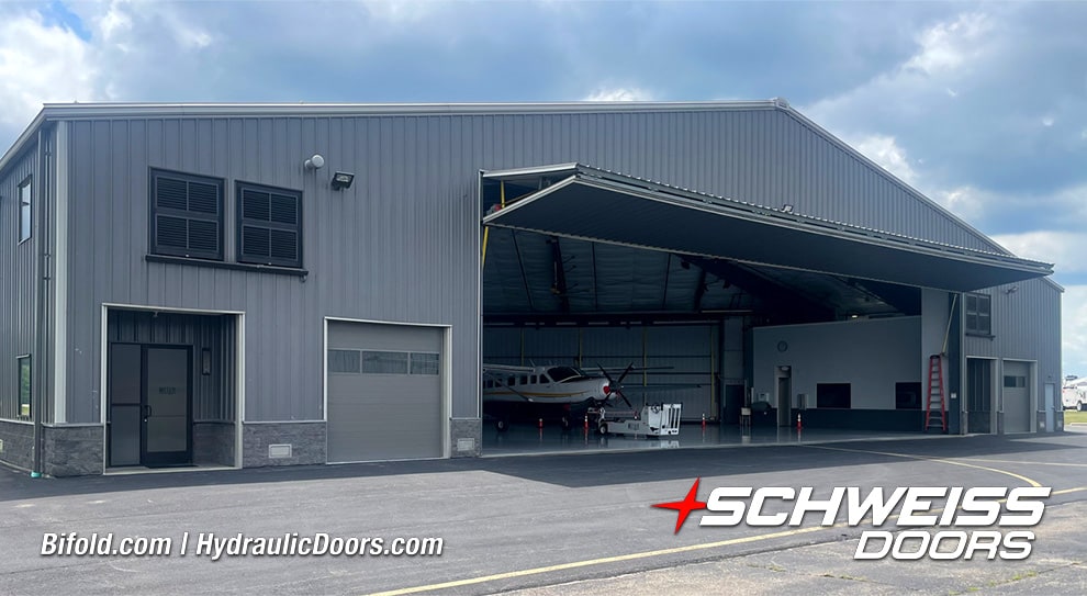 Exterior view of open Schweiss liftstrap bifold hangar door fitted on Brad Mottier's hangar