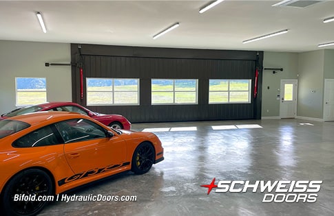 Interior view of cars parked near closed Schweiss hydraulic door fitted on Moore Carn Barn