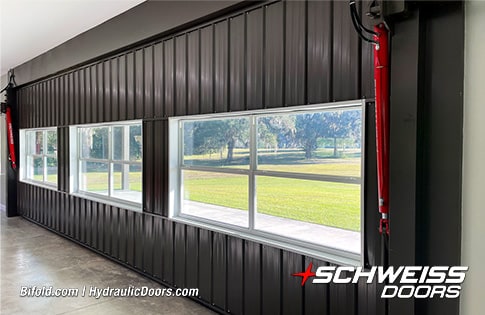 Interior closeup view of Schweiss hydraulic door fitted on Moore Car Barn shown closed