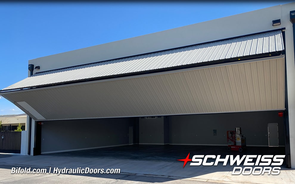 Schweiss liftstrap bifold hangar door installed by Rob Evans on hangar shown opening