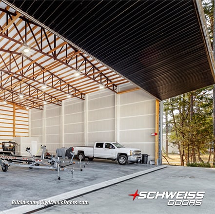 Angled view of Schweiss bifold hangar door installed on Roche Harbor hangar shown open