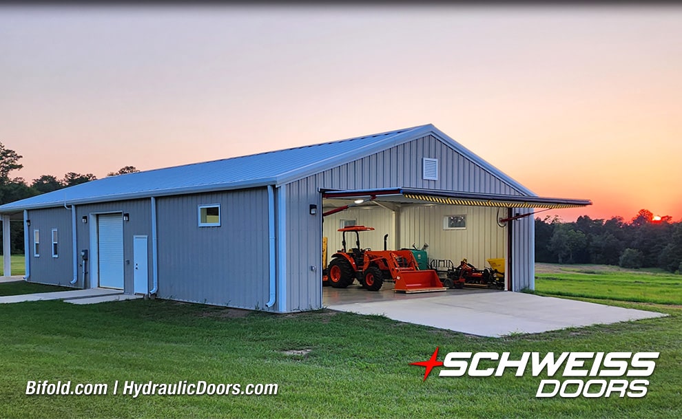 Wide view of open Schweiss hydraulic door installed on building by Ross Helwig