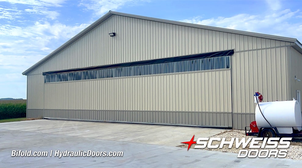 Exterior view of Schweiss hydraulic hangar door installed on Sam Mast's hangar shown closed