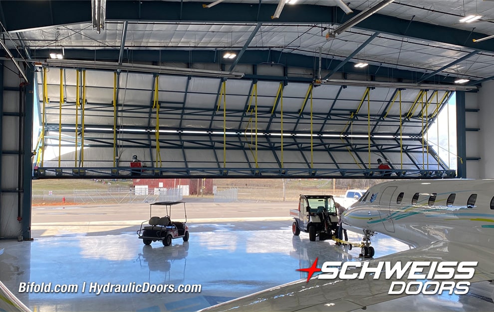 Interior view of Schweiss bifold liftstrap hangar door fitted on SEI Hangar shown opening