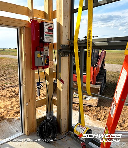 Closeup of Schweiss liftstraps and electrical unit used to operate Schweiss bifold hangar door on Steve Allen's hangar during installation