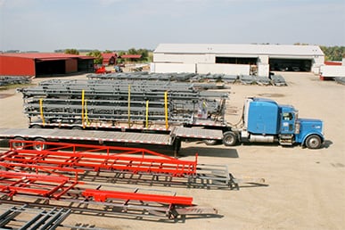 Blue Schweiss semi truck loaded with a door frame