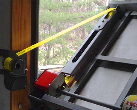 Strap Latch Bifold door protects against wind gusts