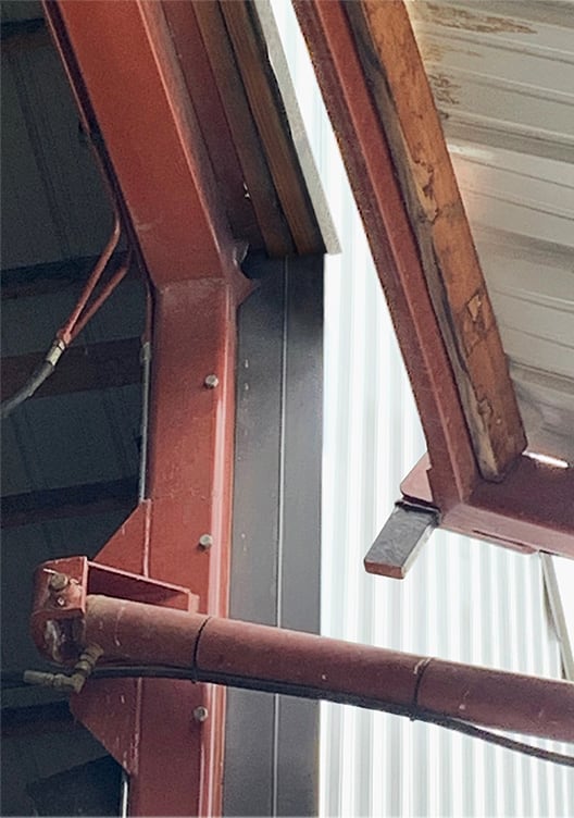 Closeup view of what failed on this hydraulic door during a storm - not a Schweiss Door!