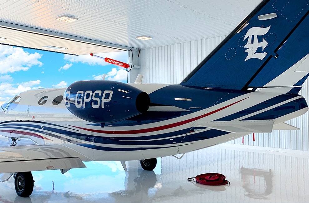 Large jet plane parked in commercial hangar fitted with Schweiss hydraulic door