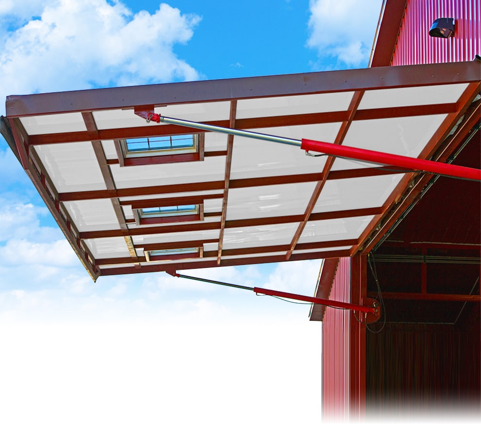 Schweiss one piece hydraulic door installed on a farm building shown open from the exterior