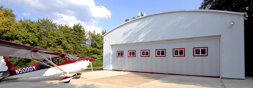 Schweiss Airpark Door clad with sheeting and airplane ready for flight 