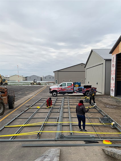 Lift straps being put on a Schweiss bifold door as it is being prepped for installation