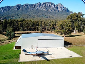 Schweiss bifold door installed on hangar at The Vale in Tasmania