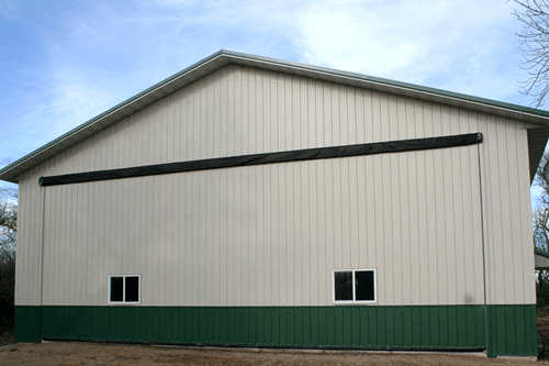 Clean looking Schweiss Door on heated equipment storage shed/shop seals weathertight  