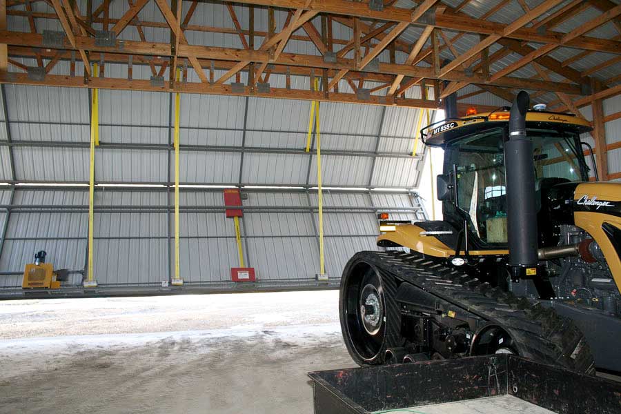 Tractor getting ready to exit storage building through Schweiss bifold door 