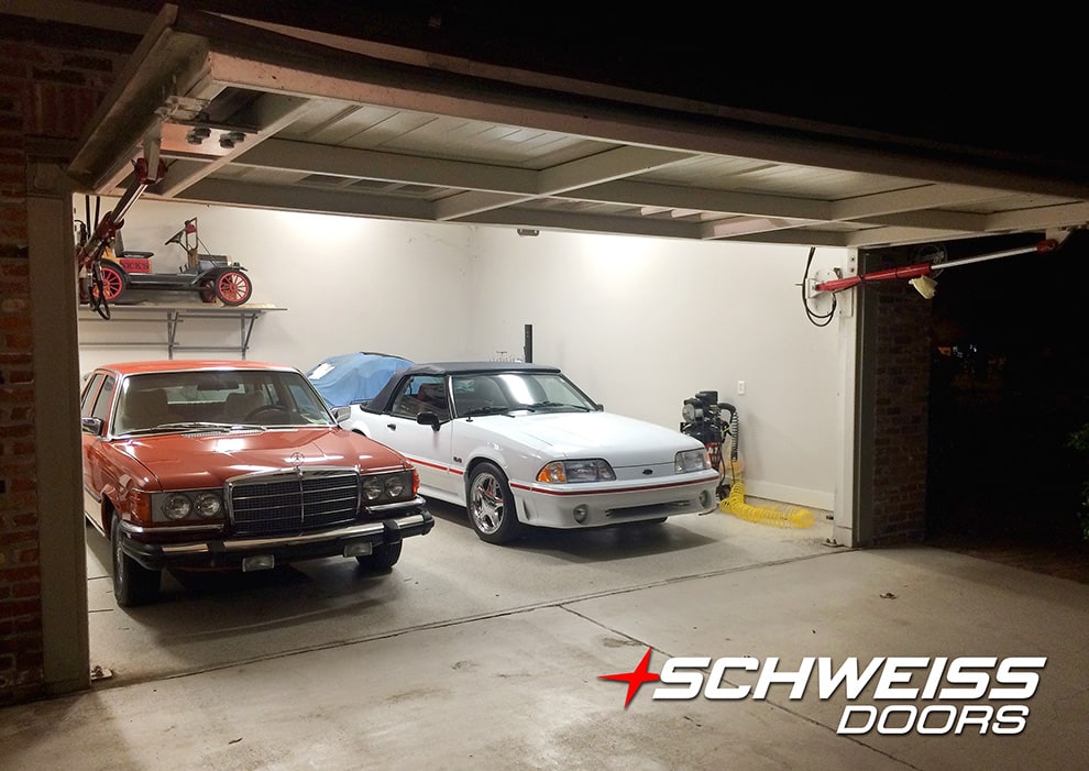 Some of Frank Bacque's car collection, parked in his garage thats fitted with a Schweiss hydraulic door shown open