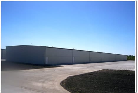 Row of T-Hangars with a few of the 132 bifold doors at Bult airfield