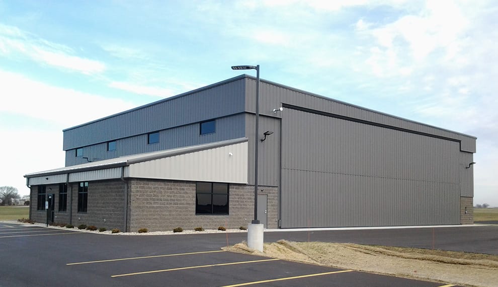 Cloudkisser hangar at Southern Wisconsin Regional Airport fitted with Schweiss bifold liftstrap door shown closed
