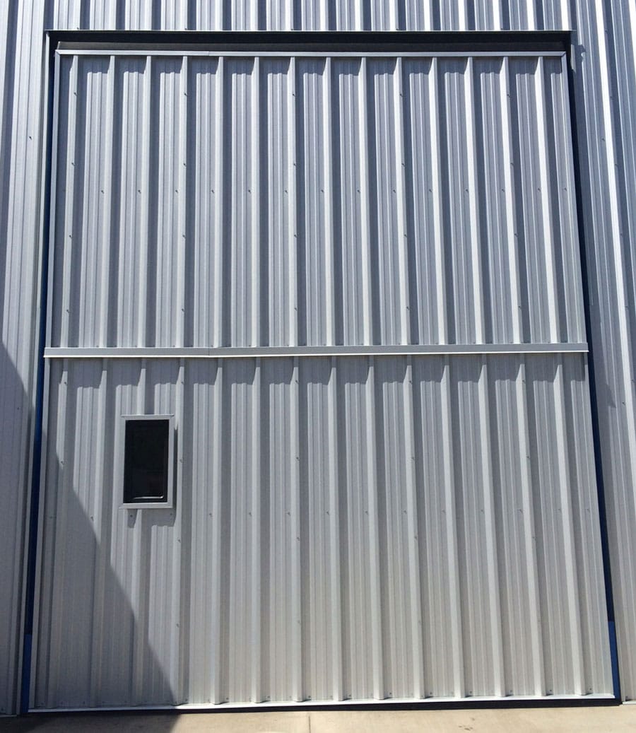 Steel siding on weathertight liftstrap door