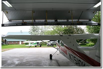 A grass landing strip sits just behind Fuchs farmsite grove. He's able to wheel out there right from his bifold hangar door.