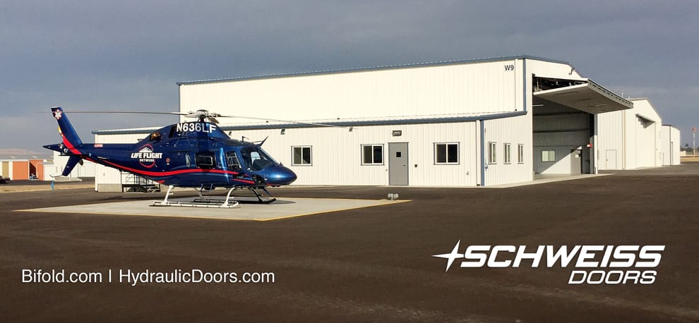 Schweiss Hangar Doors with Helicopter nearby