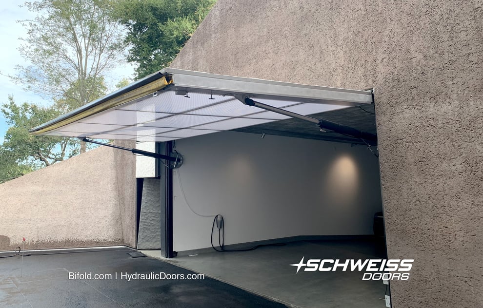 The 24' x 10' Schweiss hydraulic door fitted on the Kramlich residence shown fully open