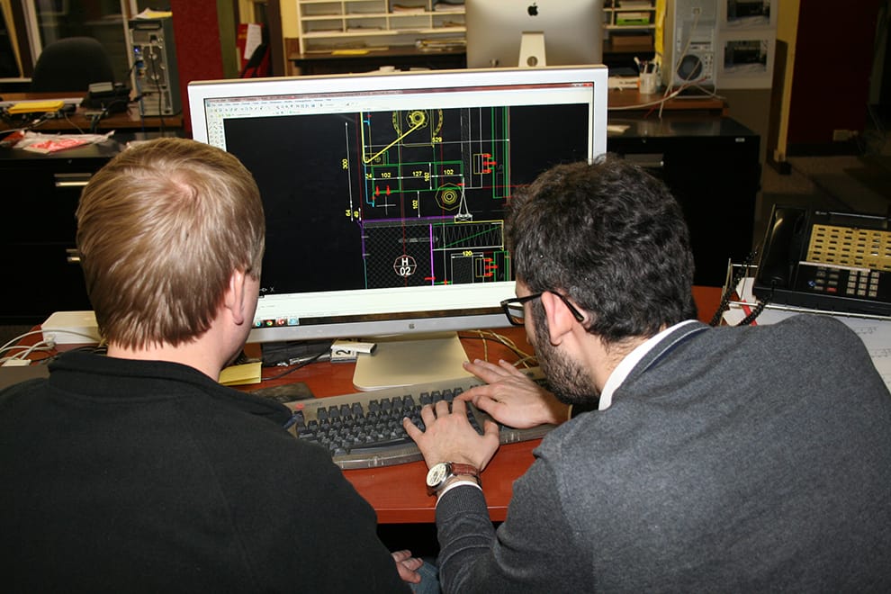 Visitor from Italy looks at AutoCAD drawings