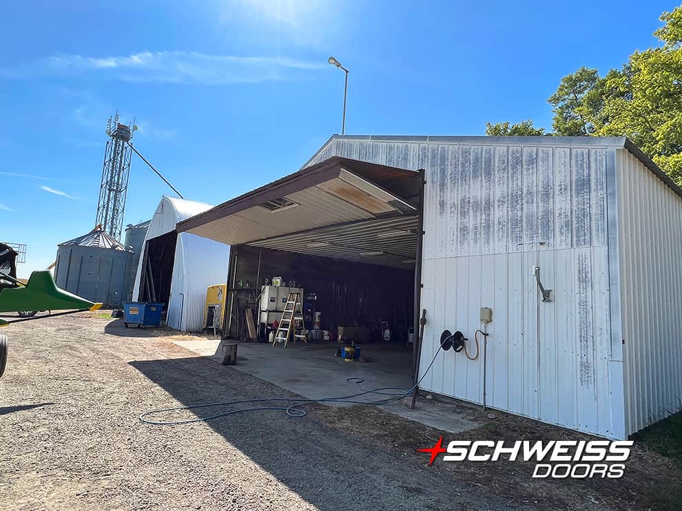 Exterior view of Keith Peterson's original vintage Schweiss bifold door on his quonset shed shown open