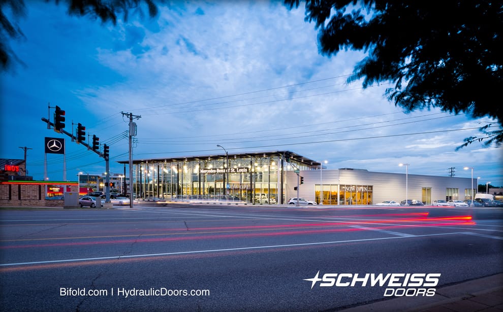 Glass Clad building and Schweiss Door allows the showroom to be viewed anytime day or night