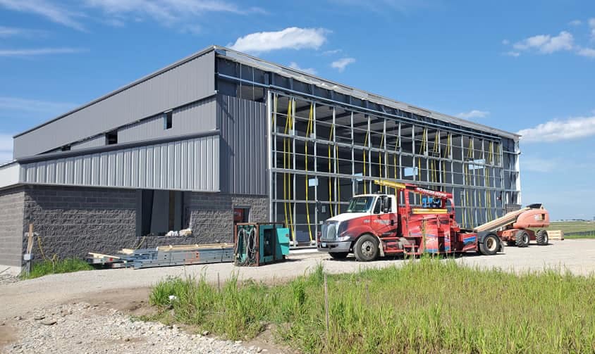 Schweiss bifold door being installed on Cloudkisser hangar built by Paulson Kimball Construction at Southern Wisconsin Regional airport shown closed