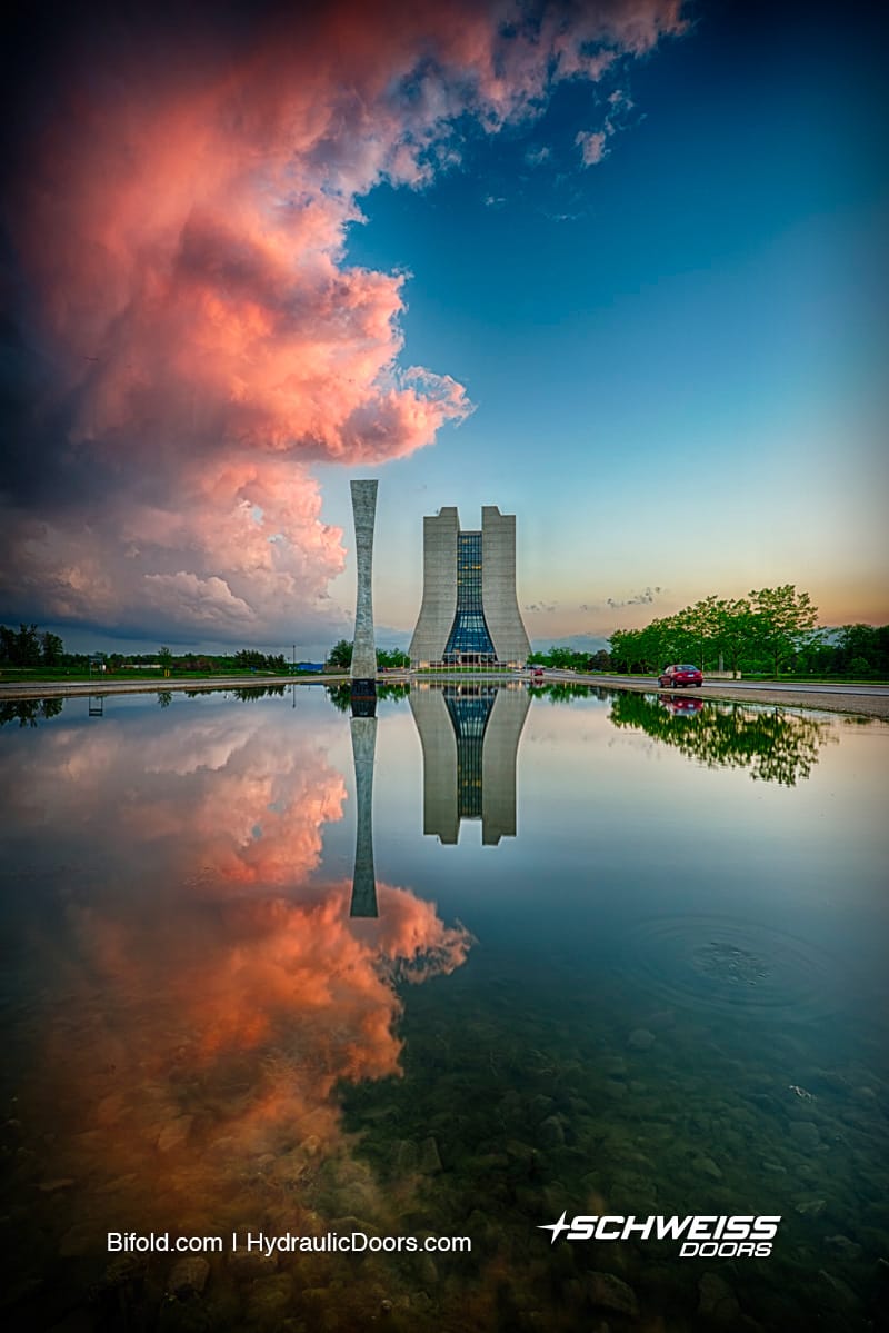 Hyperbolic obelisk is sitting front of reflecting pond
