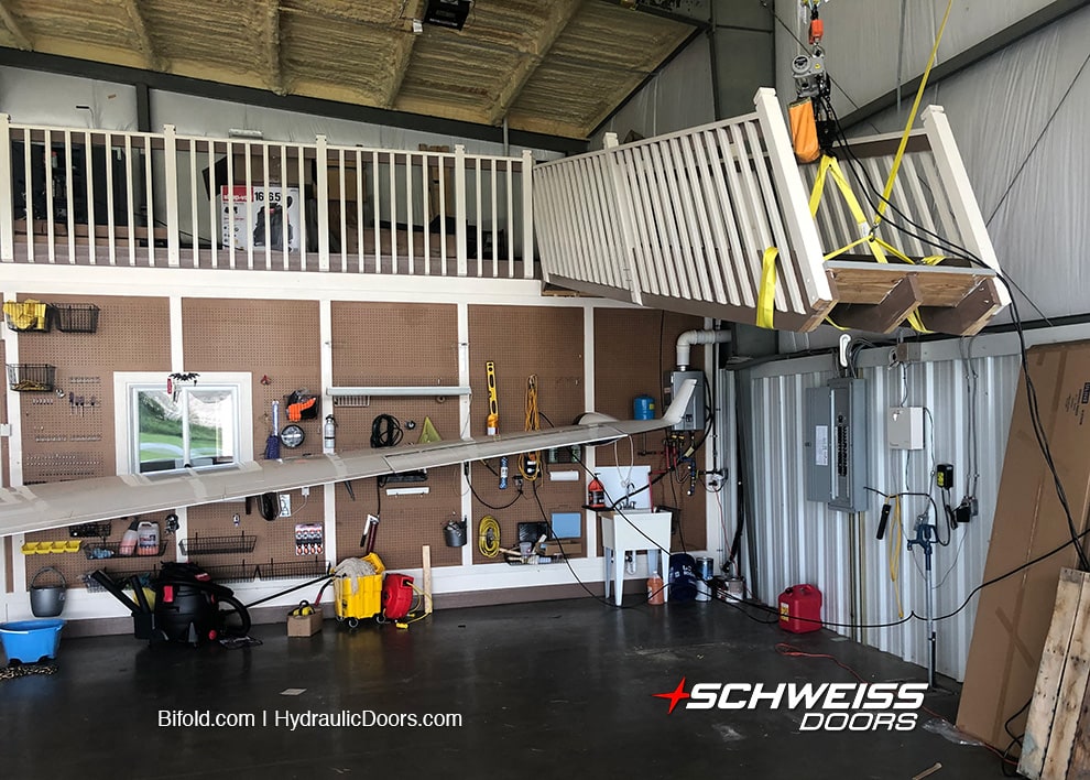 Albanese's lifting staircase in his hangar in North Carolina, created to gain more parking space