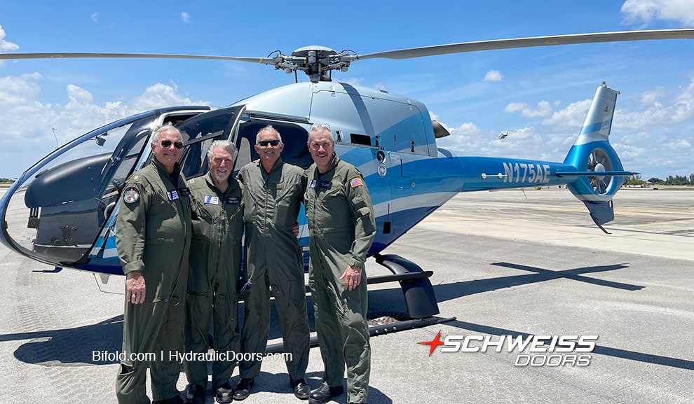Tom Powers, Ron Kaplan, Jack Fitzgerald and Arvid Albanese standing for a picture in front of a helicopter
