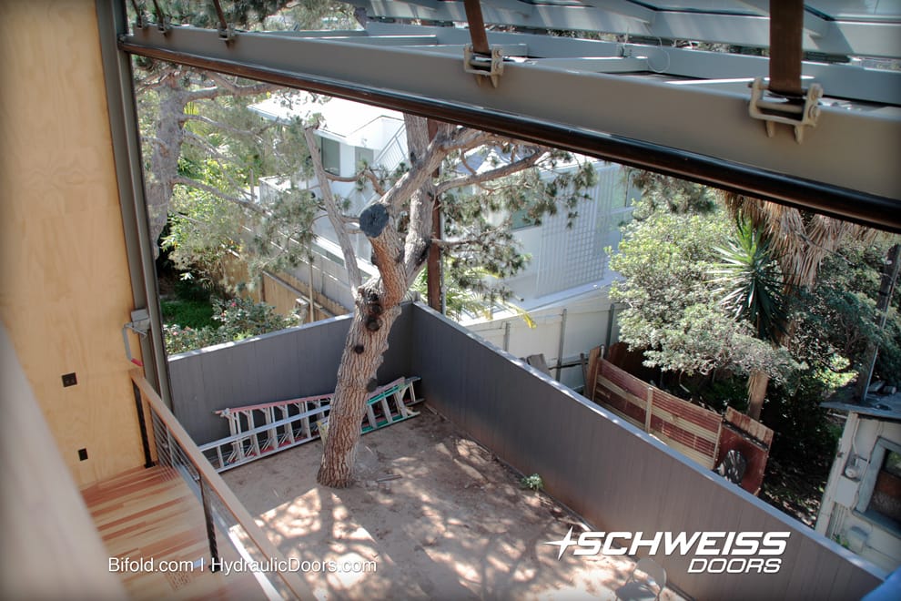 With trees in close proximity to door, the Schweiss bifold glass door was the correct choice