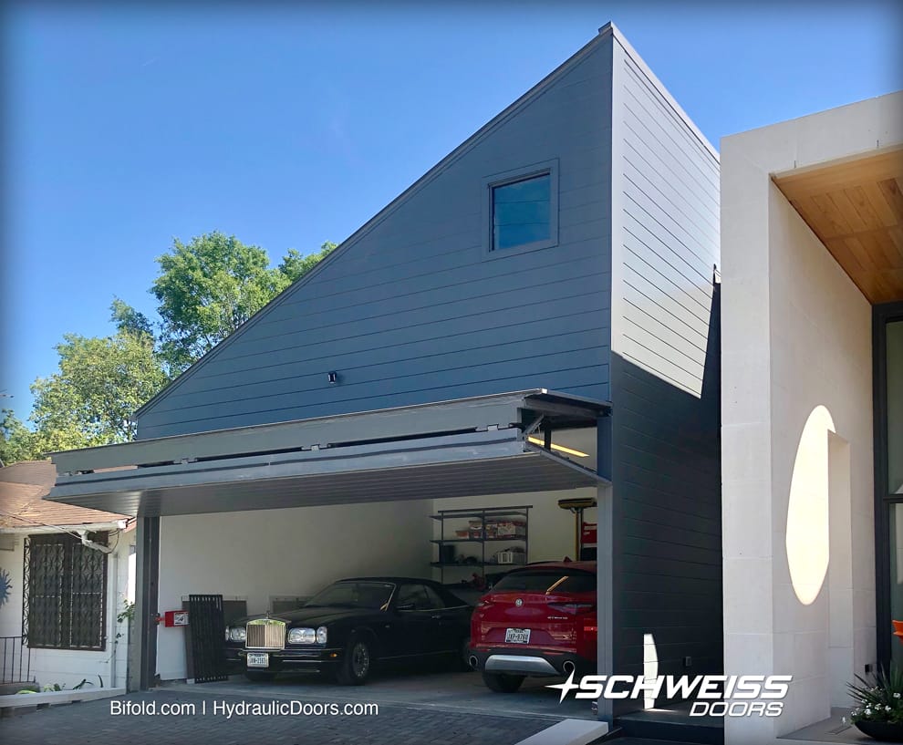 A canopy adds shade to the garage when the Schweiss Bifold Doors is in the open position.
