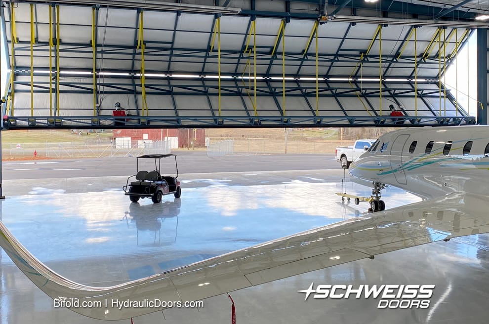 80 ft Schweiss bifold door fitted on SEI's Hangar A at Morristown Regional Airport shown opening from inside